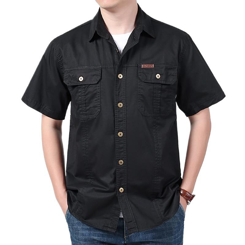 man wearing black short sleeve button-up shirt with chest pockets and blue jeans