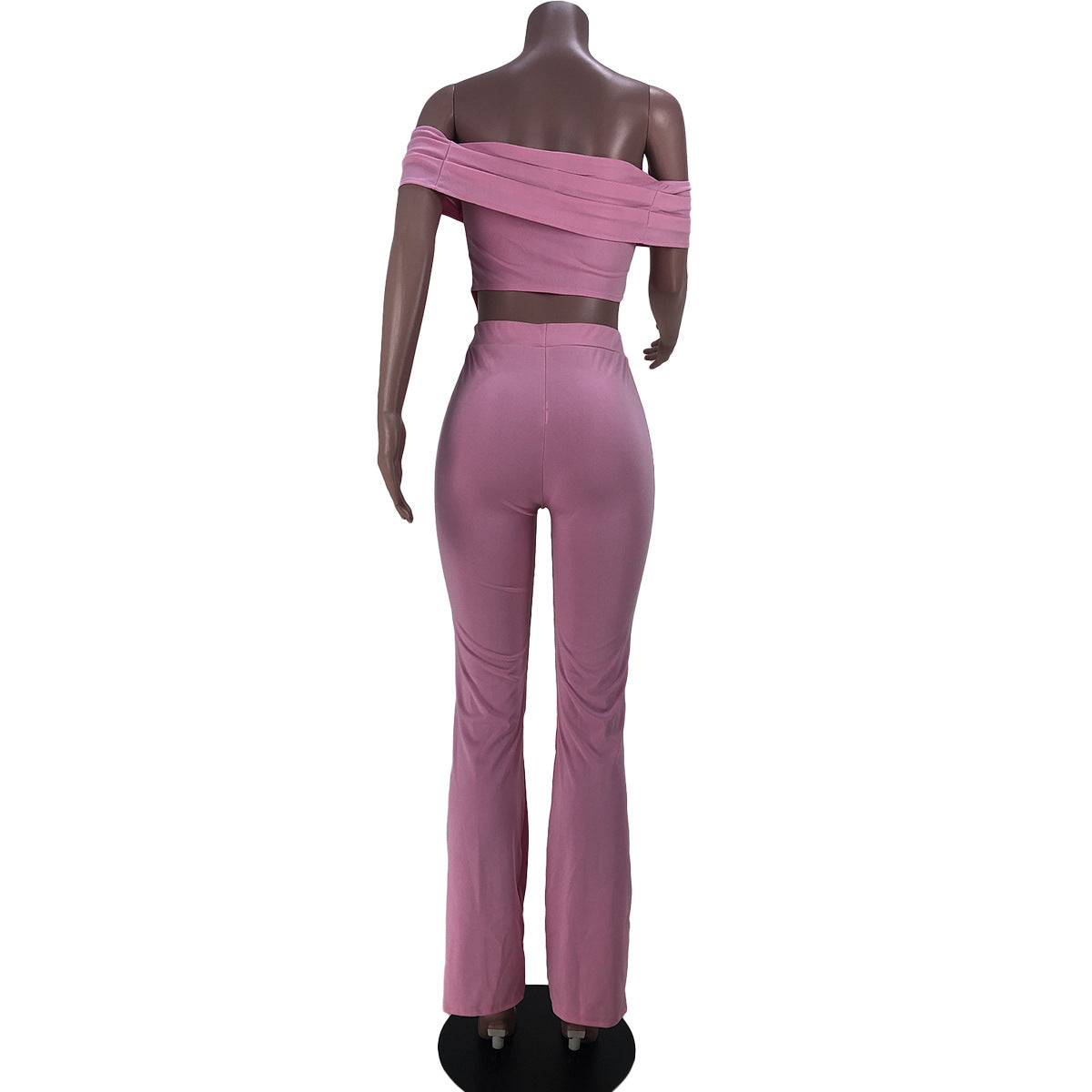 Back view of mannequin wearing pink off-shoulder crop top and high-waisted flare pants outfit