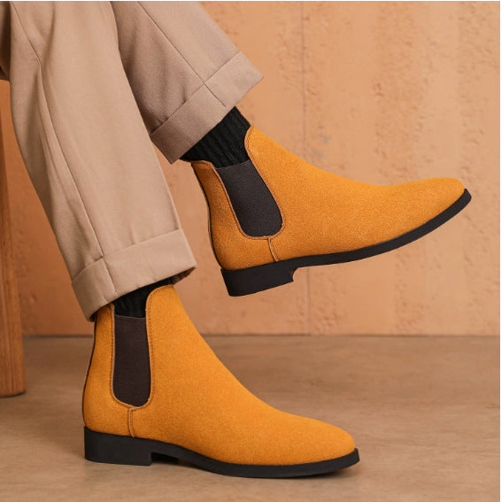 Mustard suede Chelsea boots with black elastic sides worn with beige pants and black socks