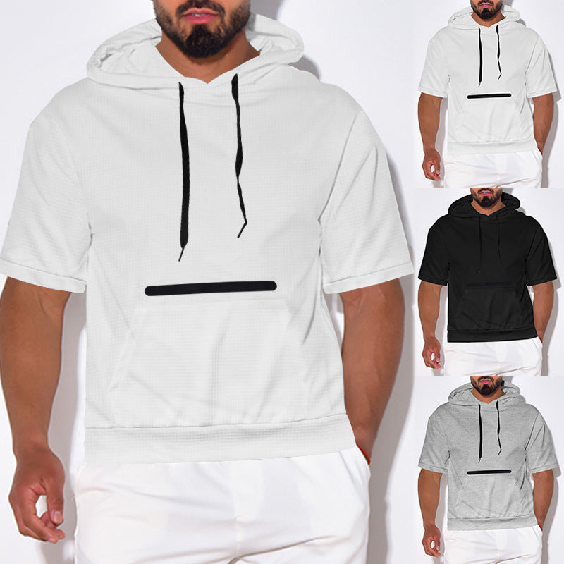 Male model wearing short sleeve hooded sweatshirt in white, black, and gray with black drawstrings and front pocket