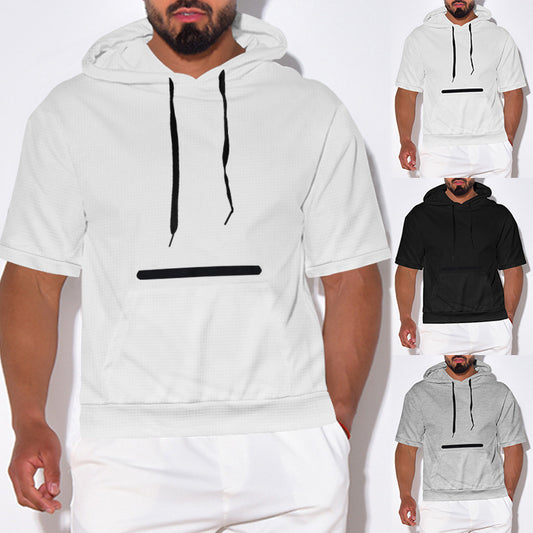 Male model wearing short sleeve hooded sweatshirt in white, black, and gray with black drawstrings and front pocket