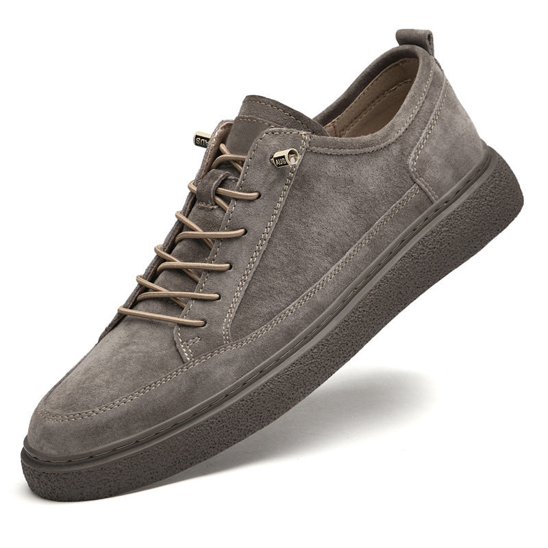 Gray suede casual sneaker with brown laces and textured rubber sole on white background