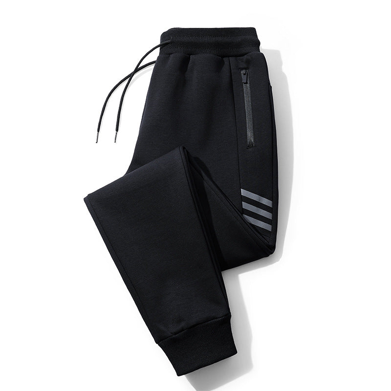 Black jogger pants with ribbed cuffs, drawstring waist, side zipper pocket, and reflective stripes