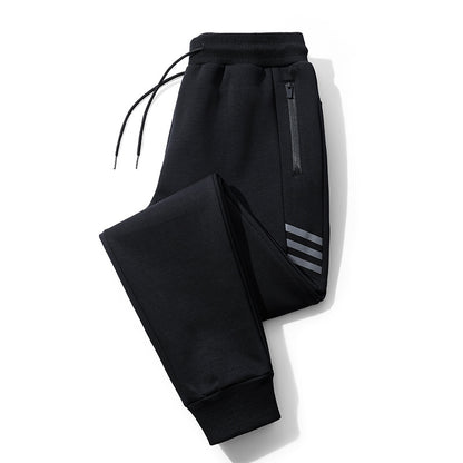 Black jogger pants with ribbed cuffs, drawstring waist, side zipper pocket, and reflective stripes