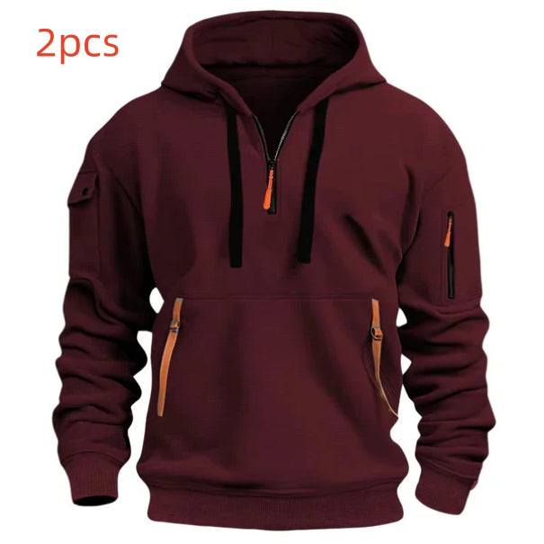 Maroon hooded sweatshirt with front zipper and multiple zippered pockets, black drawstrings, and ribbed cuffs