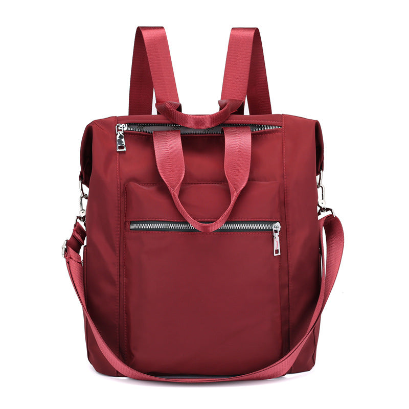 Stylish red backpack with multiple zippered pockets and adjustable shoulder straps
