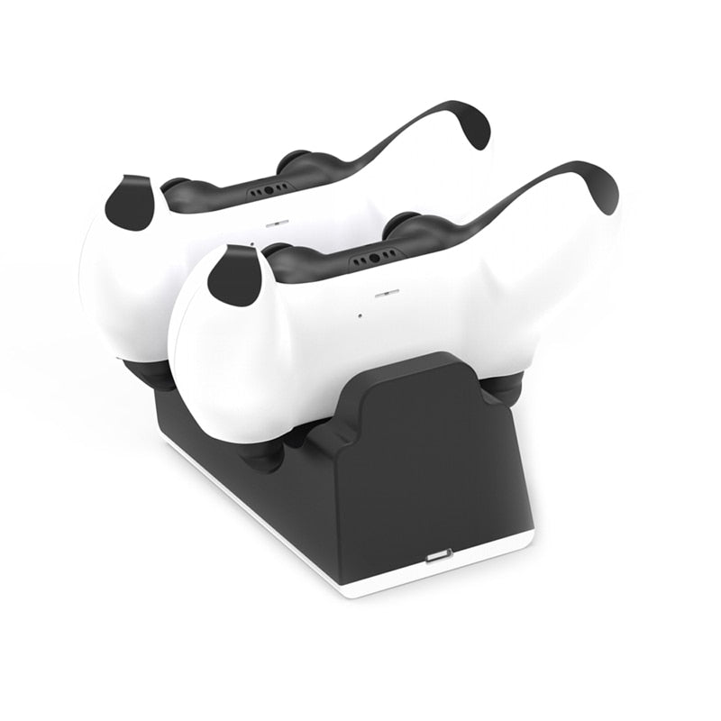 Dual white and black gaming controllers on a black charging dock with USB-C port