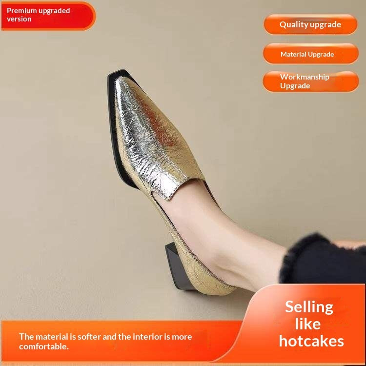 Gold shiny pointed toe women's low block heel shoes on beige floor