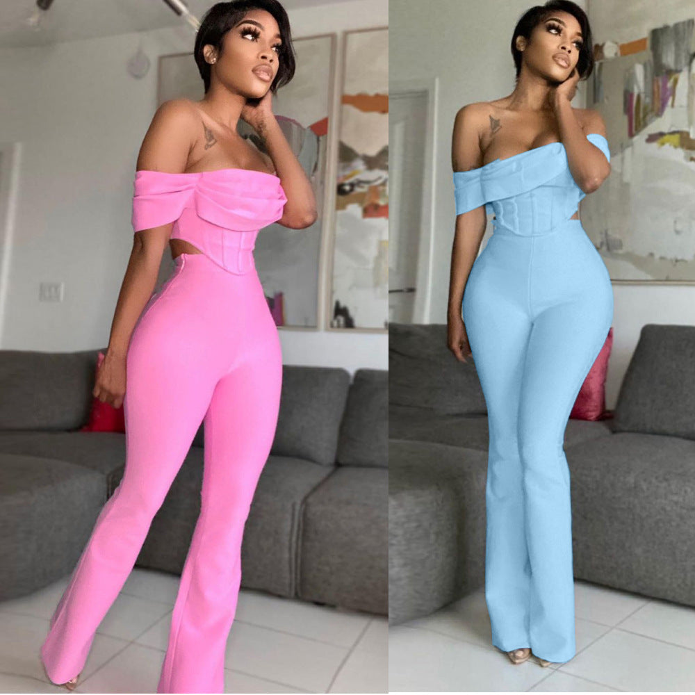Woman modeling off-shoulder fitted jumpsuits in pink and blue in modern living room