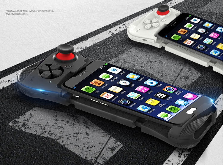 Smartphones attached to black and white gaming controllers with joysticks on asphalt background