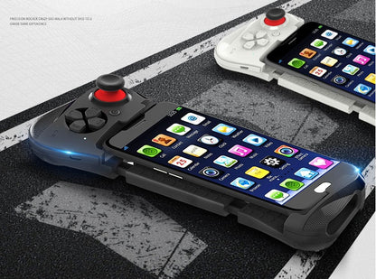 Smartphones attached to black and white gaming controllers with joysticks on asphalt background