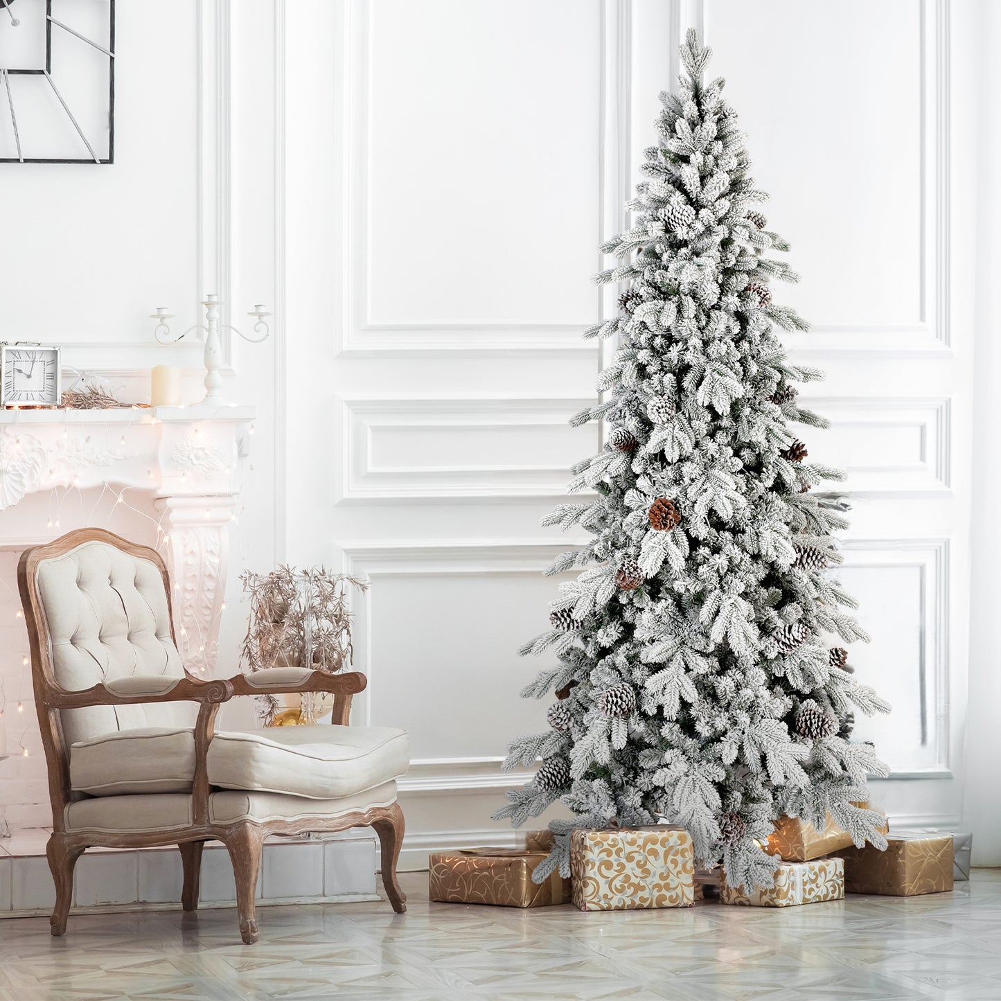 Elegant white living room with a frosted Christmas tree decorated with pinecones and gold wrapped gifts