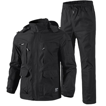 Black tactical jacket and pants set with multiple pockets and elastic cuffs on white background