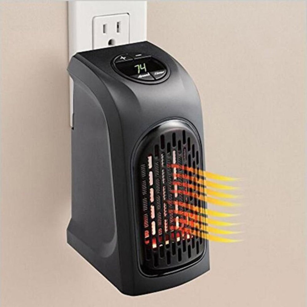 Black portable electric space heater plugged into wall outlet with digital temperature display set at 74°F