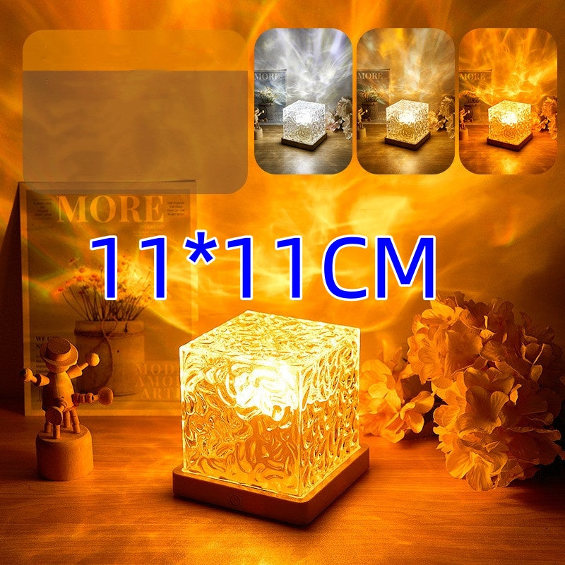 11x11 cm decorative cube night light casting warm abstract patterns on table with flowers and wooden figure