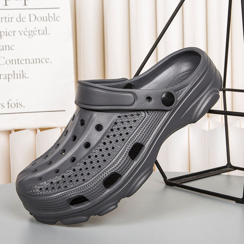 Black breathable lightweight clog with ventilation holes and adjustable strap on gray surface
