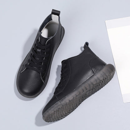 Black leather high-top sneakers with black laces and translucent rubber soles on gray background