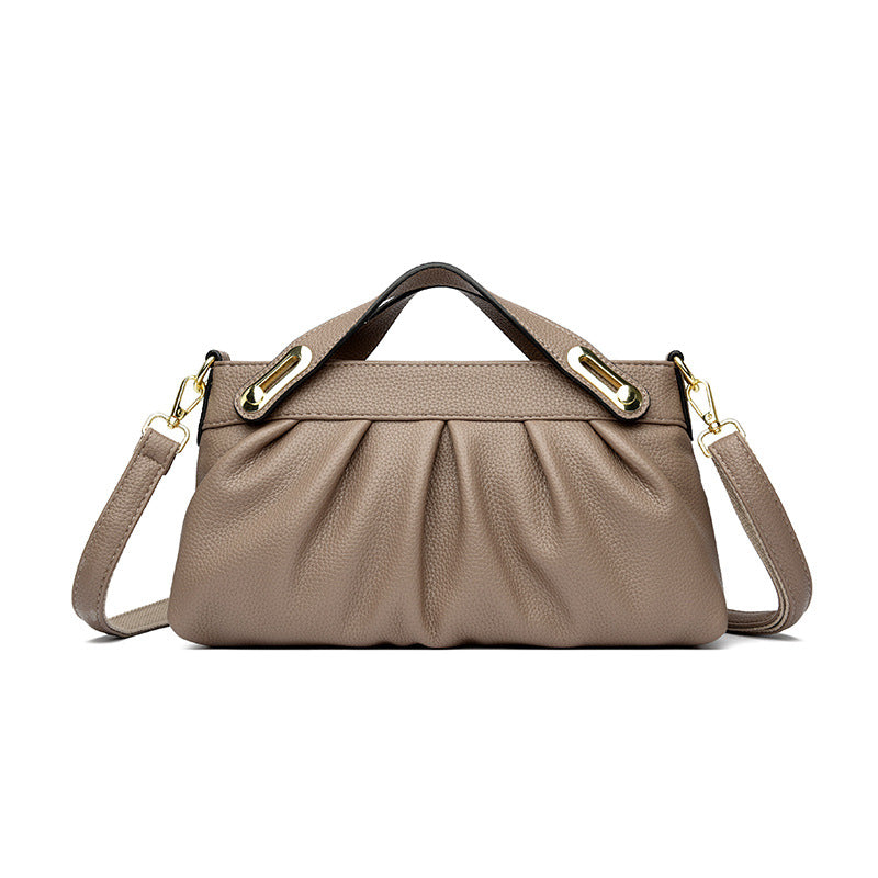 Taupe leather handbag with gold hardware, pleated design, top handles, and removable shoulder strap