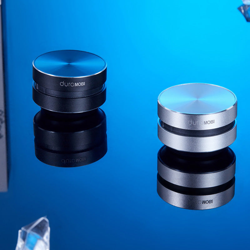 Two DuraMobi round aluminum phone holders in black and silver on reflective blue surface