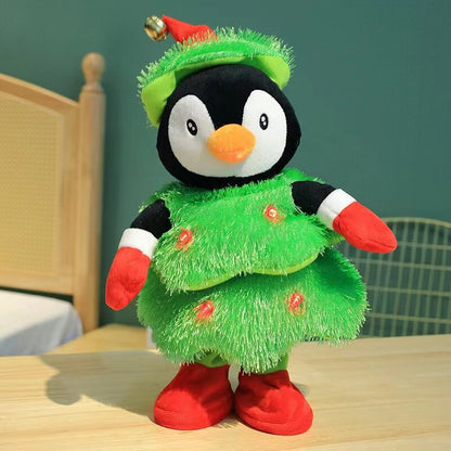 Plush penguin toy dressed in Christmas tree costume with red gloves, boots, and Santa hat on wooden table