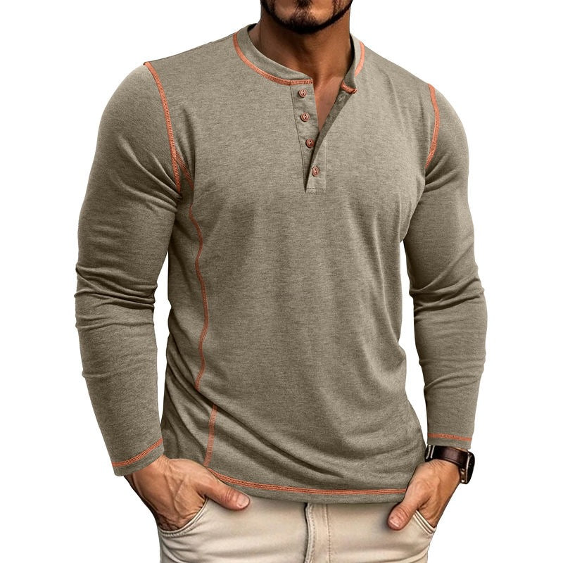 Man wearing fitted long-sleeve henley shirt with orange stitching and beige pants