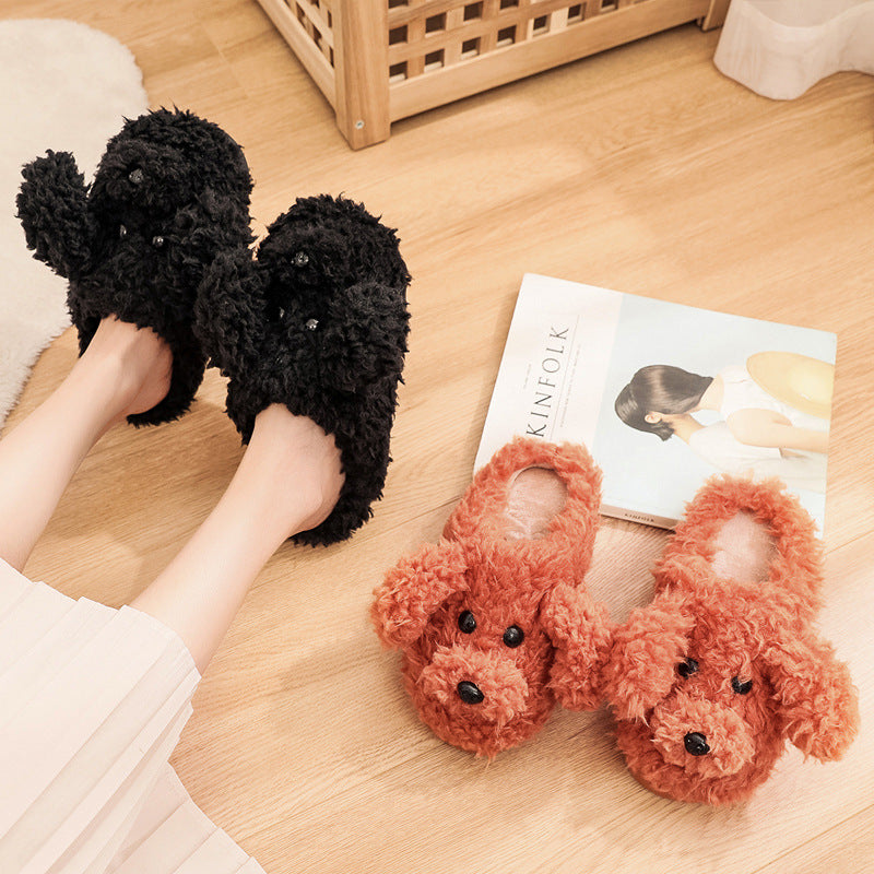 Cozy black and brown plush dog-shaped slippers on wooden floor with Kinfolk magazine