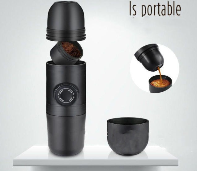 Portable black coffee maker with detachable parts and built-in dial on a white surface