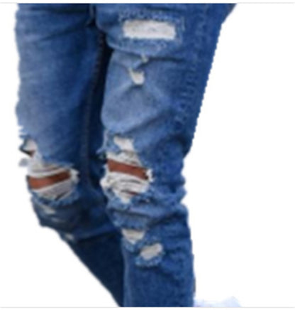 Close-up of blue distressed ripped jeans with multiple tears and frayed patches on legs
