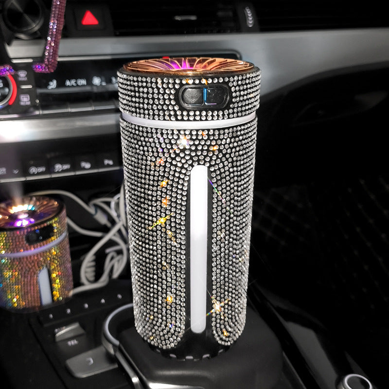 Glittering rhinestone-covered portable air purifier placed in a car cup holder with controls visible