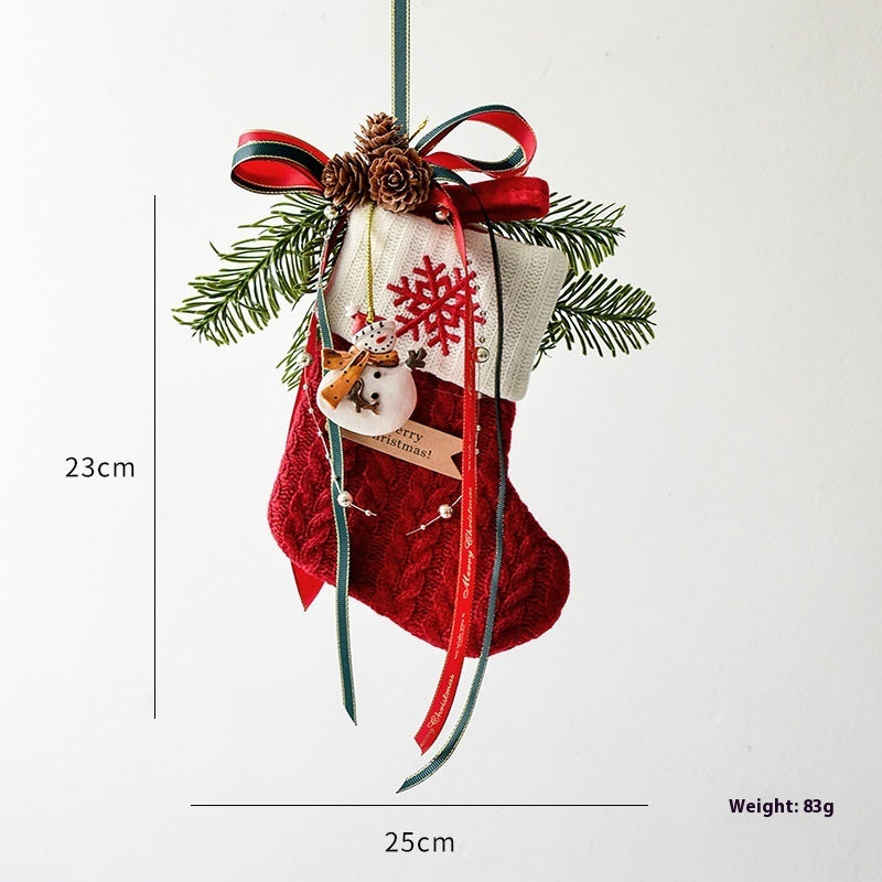 Red and white Christmas stocking ornament with snowflake, pinecones, ribbons, and greenery hanging, 23x25cm