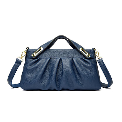 Elegant navy blue leather handbag with gold hardware and detachable shoulder strap