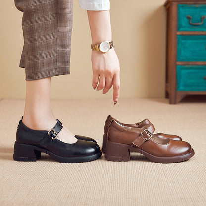 Woman wearing black Mary Jane shoes with buckle, pointing at brown Mary Jane shoes on carpeted floor