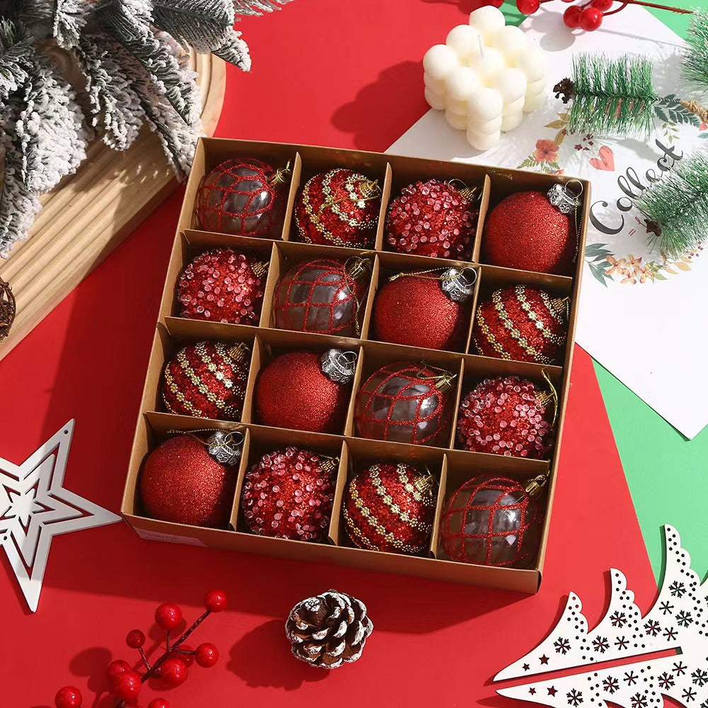 Box of 16 red Christmas ornaments with glitter, sequins, and striped patterns on red and green background