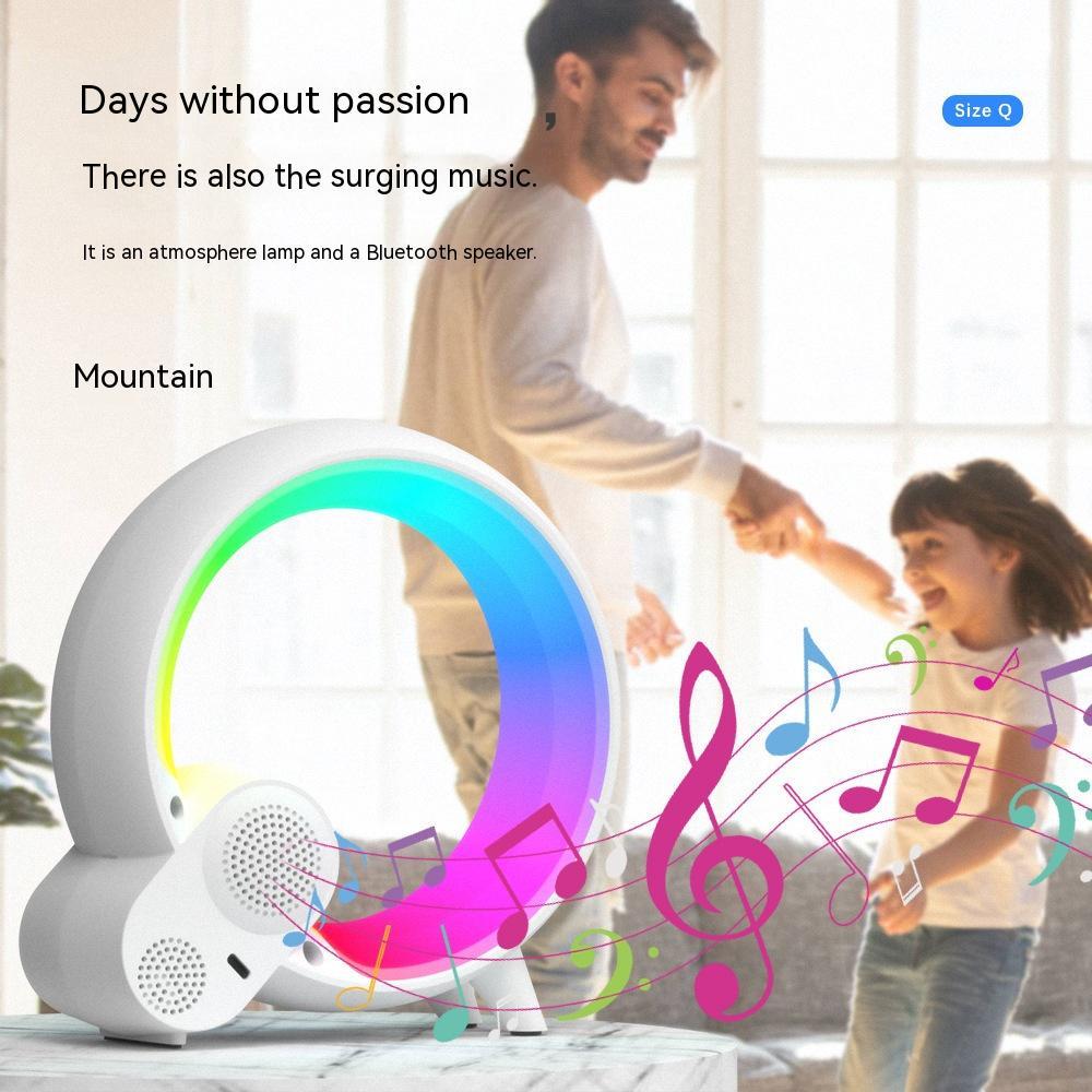 Modern circular Bluetooth speaker with colorful LED atmosphere lamp on table, father and child dancing