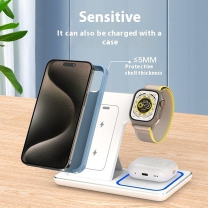 White multi-device wireless charging station with a smartphone, smartwatch, and wireless earbuds on wooden table
