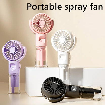 Portable spray fans in pink, white, purple, and black with mist function displayed on white blocks