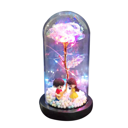 LED decorative dome with glowing rose and miniature boy playing guitar with girl figurine
