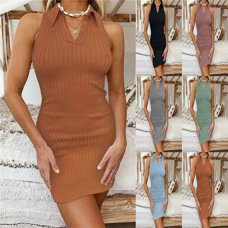 Woman wearing a ribbed, sleeveless, buttoned collar mini dress in six colors including brown, black, pink, gray, green, and blue