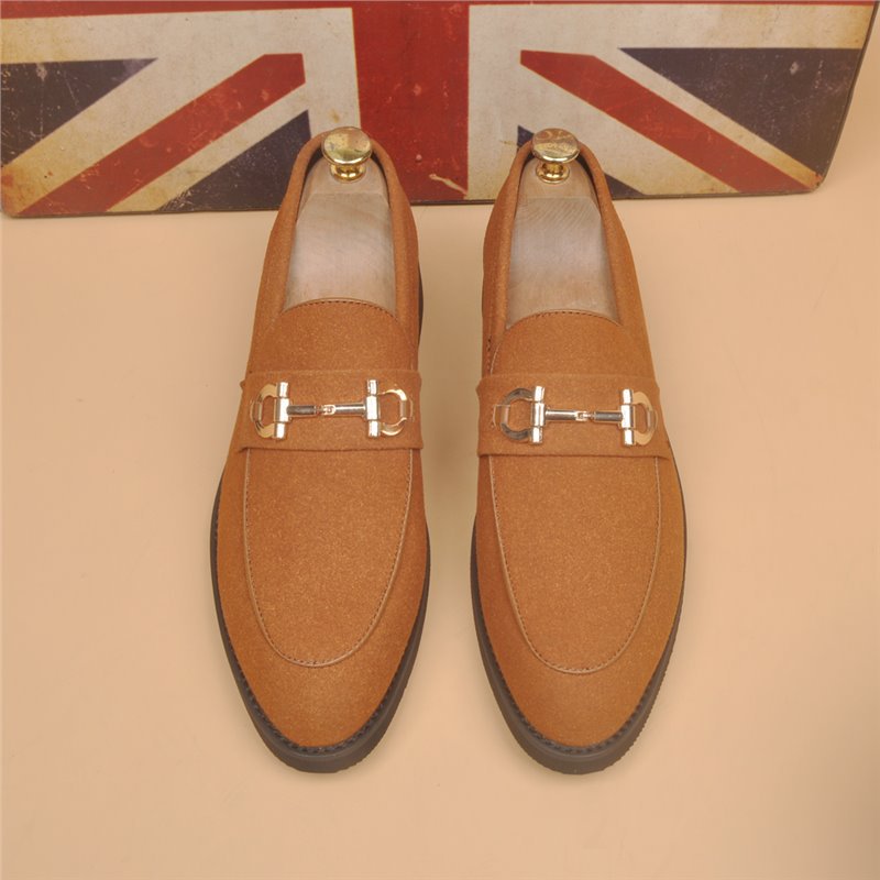 Brown suede loafers with gold horsebit detail, black sole, displayed in front of UK flag background