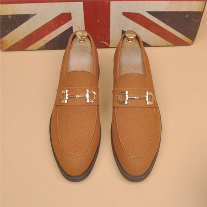 Brown suede loafers with gold horsebit detail, black sole, displayed in front of UK flag background