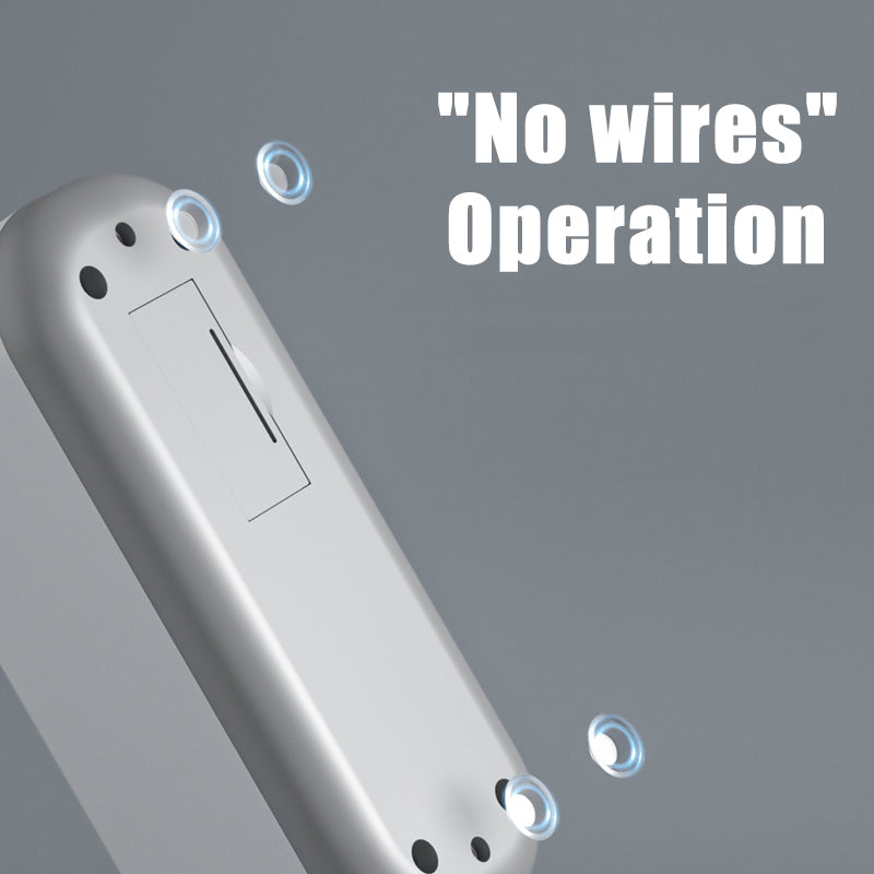 Silver wireless device with 'No wires Operation' text on gray background