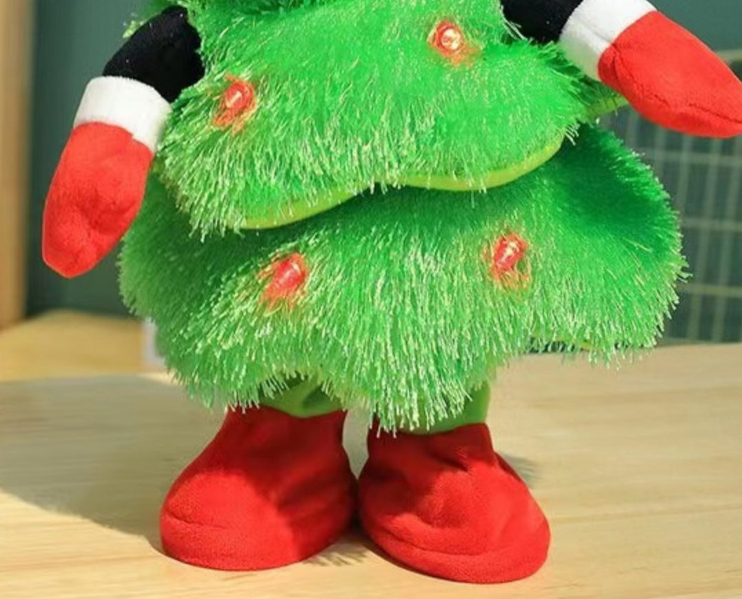 Plush Christmas tree toy with green tinsel texture, red gloves and red boots on table