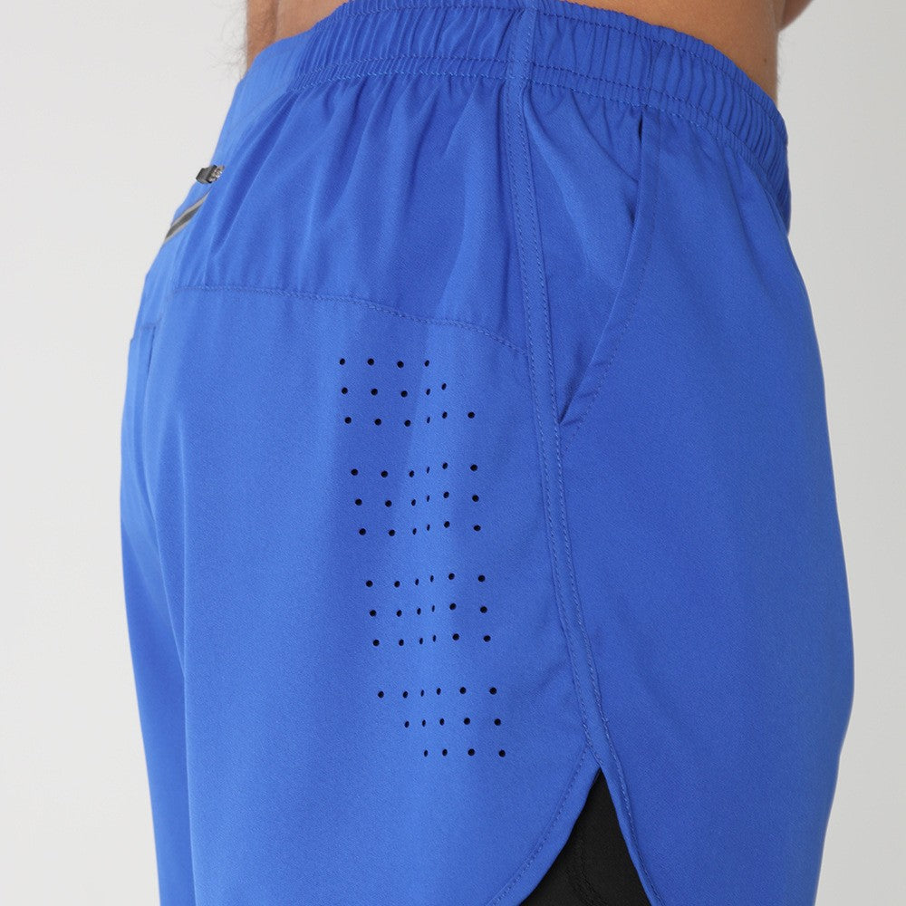 Close-up of blue athletic shorts with perforated ventilation and elastic waistband