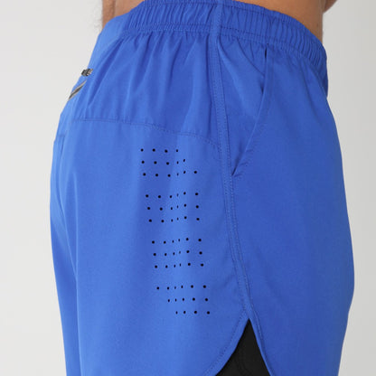 Close-up of blue athletic shorts with perforated ventilation and elastic waistband