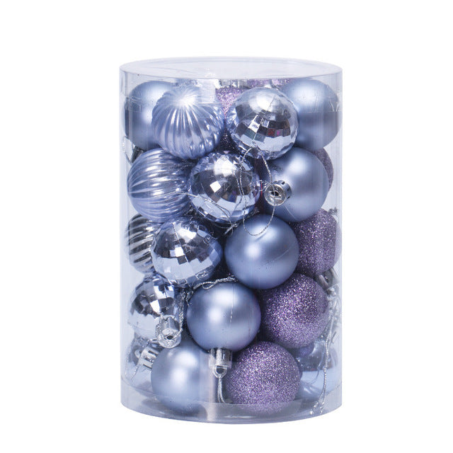 Clear cylindrical container filled with assorted silver and purple Christmas ornaments including shiny, matte, and glittery balls