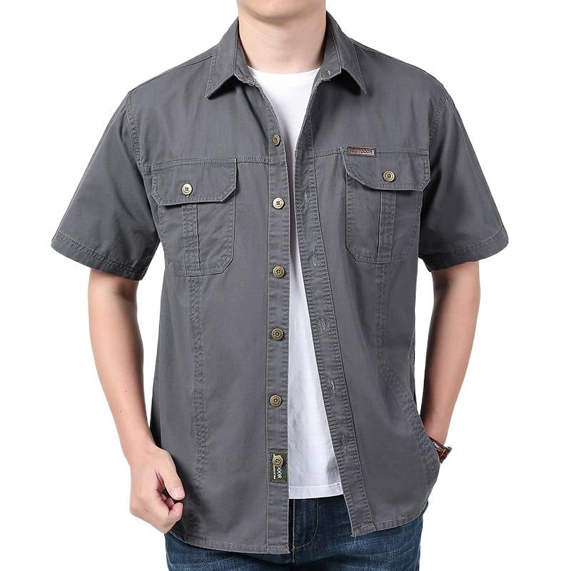 Men's casual short sleeve gray button-up shirt with front pockets over white t-shirt