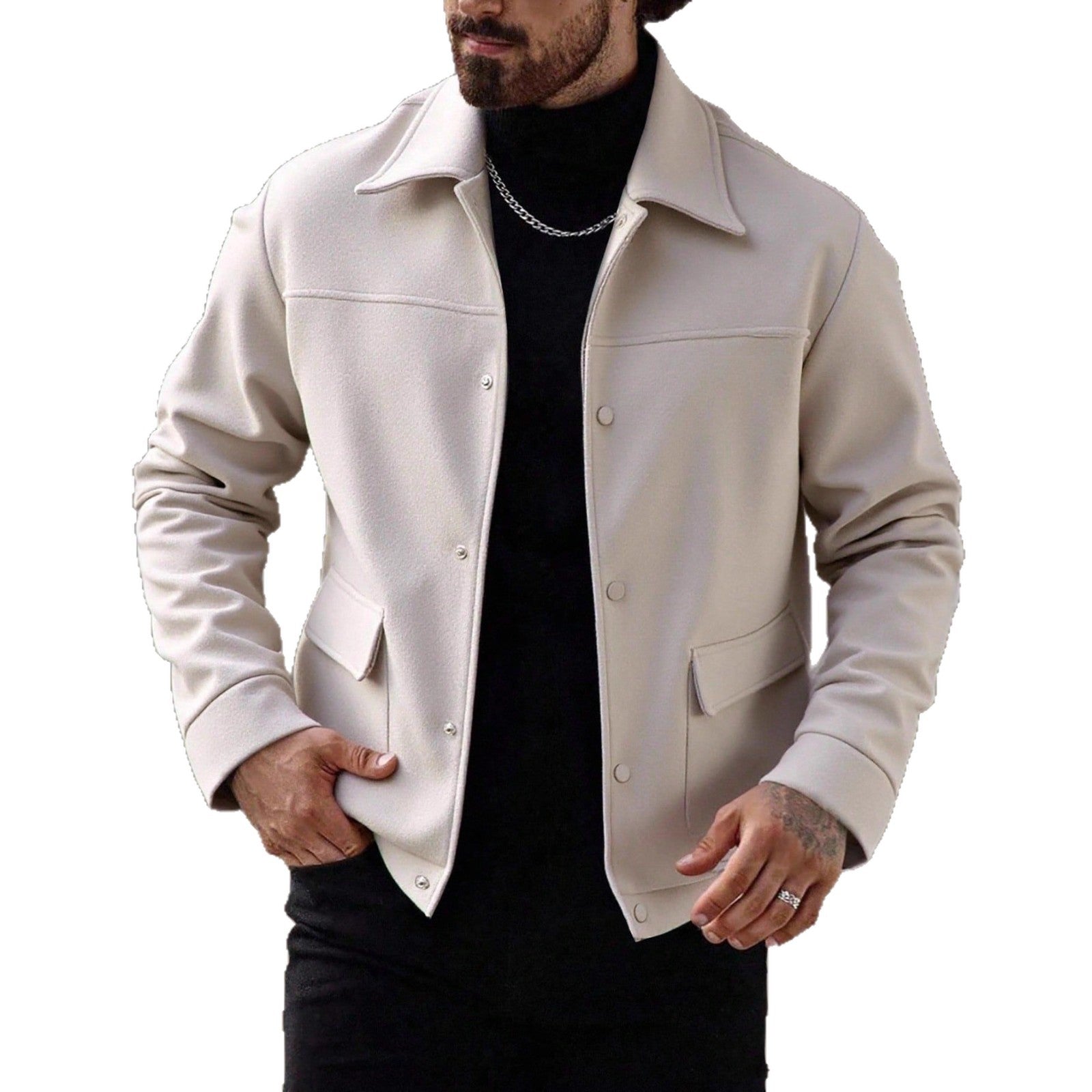 Man wearing beige button-up jacket with front pockets over black turtleneck and chain necklace