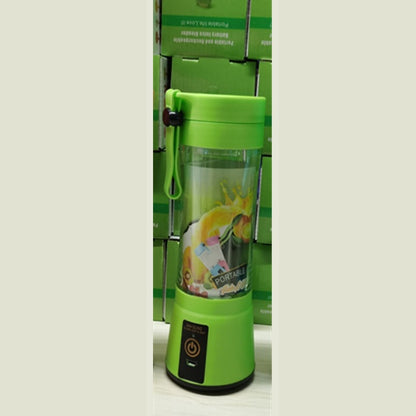 Green portable electric blender with fruit graphics and power button on base, stacked green boxes background