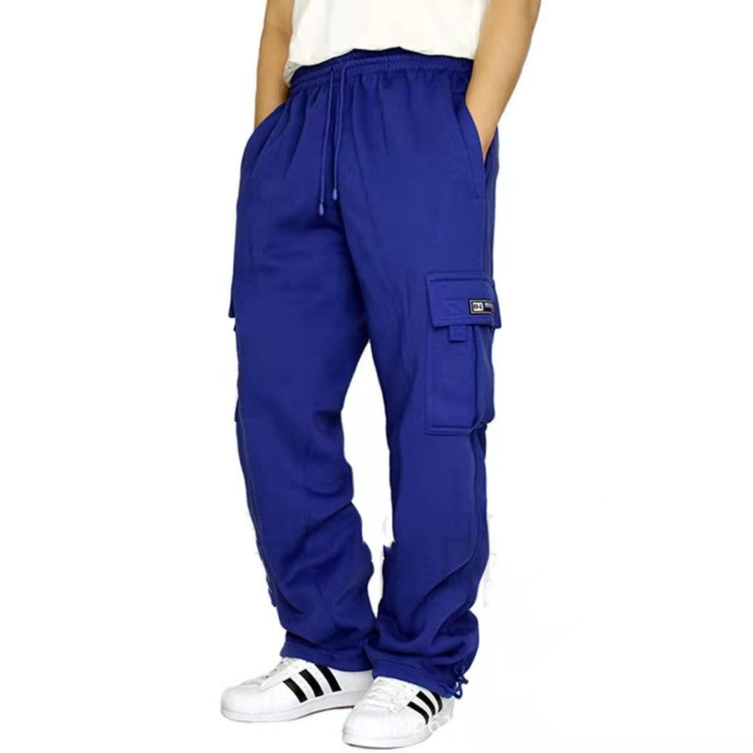 Person wearing royal blue cargo pants with side pockets and white sneakers with black stripes
