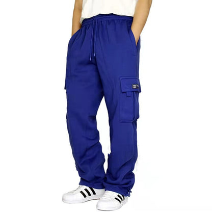 Person wearing royal blue cargo pants with side pockets and white sneakers with black stripes